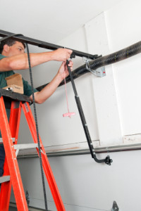 Technician repairing Garage door in Southlake TX